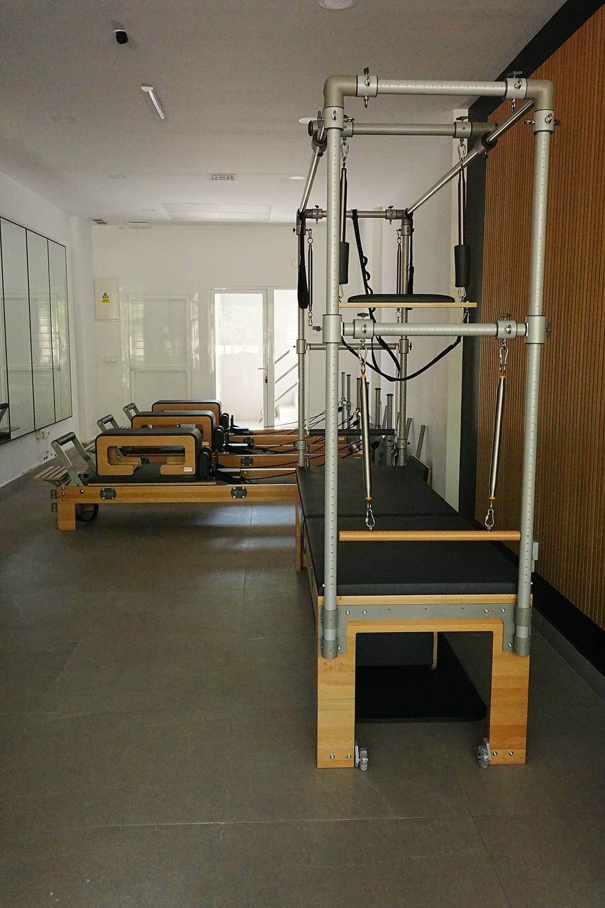 BASI Systems Cadillac by the wooden slat wall, with the reformers behind