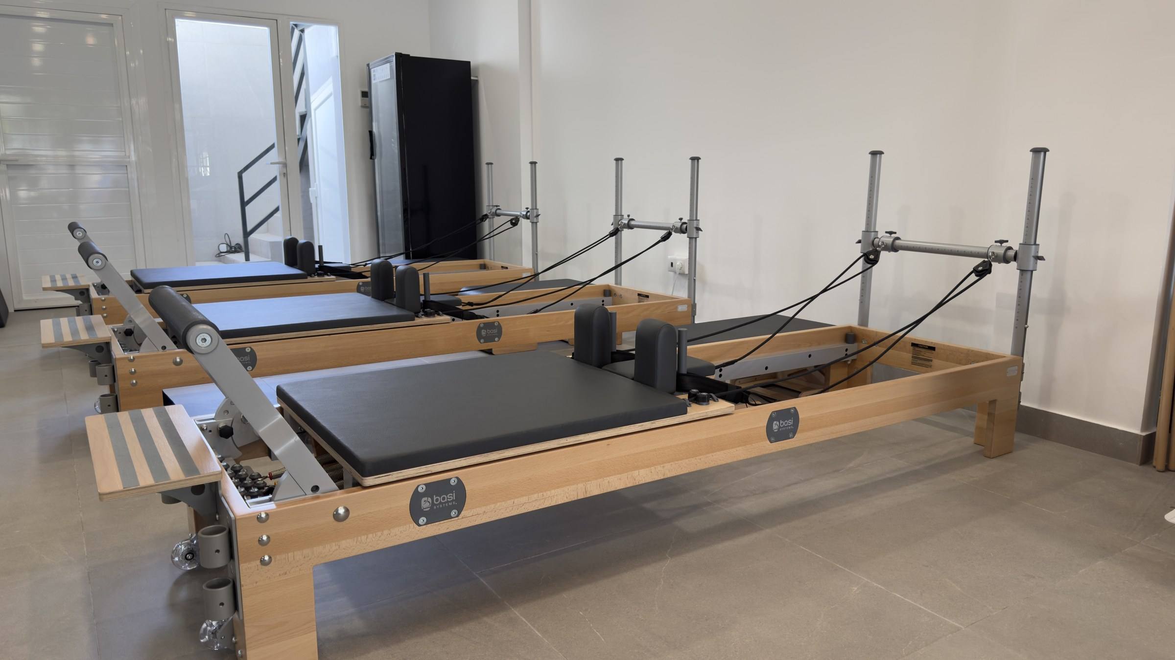 BASI Systems Reformer with its carriage and footbar in the main studio room