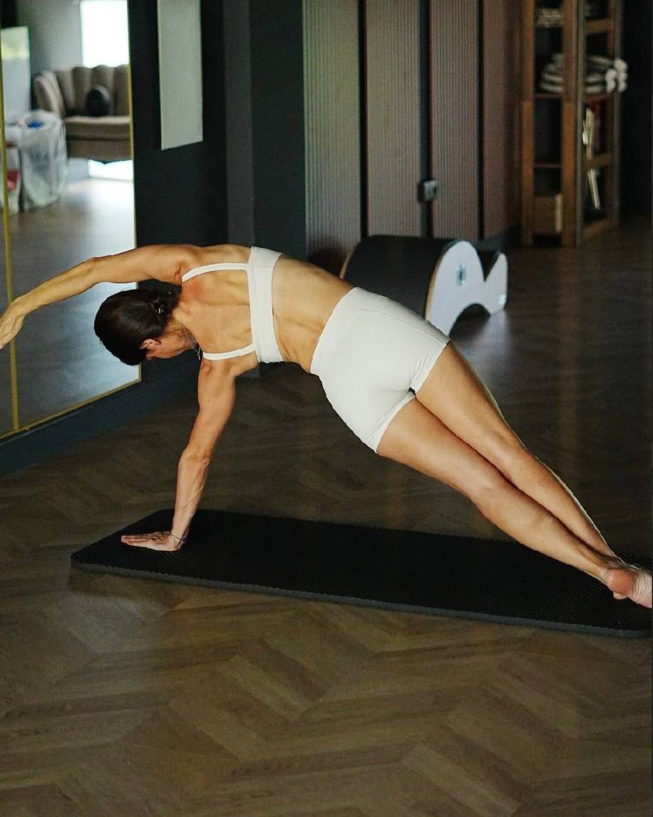 Side plank with rotation on the mat in the Mat room